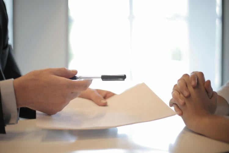 crop businessman giving contract to woman to sign