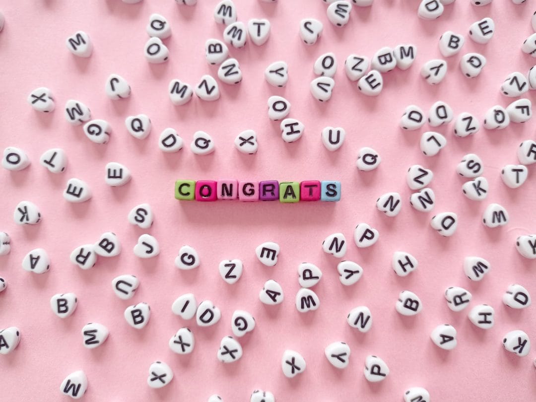 congrats text on a pink surface